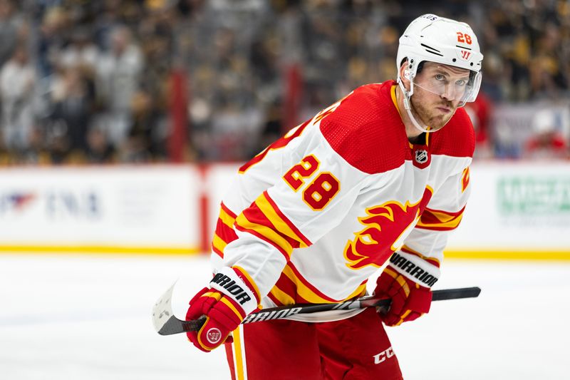 Oct 14, 2023; Pittsburgh, Pennsylvania, USA; Calgary Flames center Elias Lindholm (28) lines up for a face-off against the Pittsburgh Penguins during the second period at PPG Paints Arena. Mandatory Credit: Scott Galvin-USA TODAY Sports