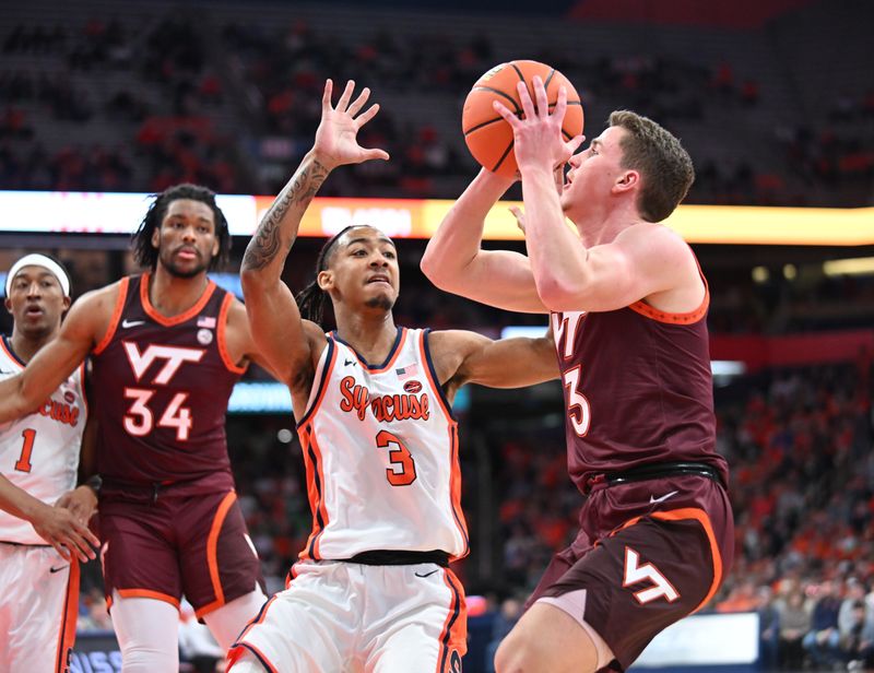 Feb 27, 2024; Syracuse, New York, USA; Virginia Tech Hokies guard Sean Pedulla looks to shoot the ball with Syracuse Orange guard Judah Mintz defending in the first half at the JMA Wireless Dome. Mandatory Credit: Mark Konezny-USA TODAY Sports