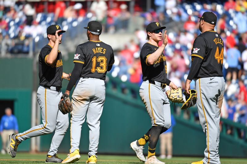 Apr 14, 2024; Philadelphia, Pennsylvania, USA; Pittsburgh Pirates outfielder Bryan Reynolds (10), third baseman Ke'Bryan Hayes (13), outfielder Jack Suwinski (65) and first baseman Rowdy Tellez (44) celebrate win  at Citizens Bank Park. Mandatory Credit: Eric Hartline-USA TODAY Sports