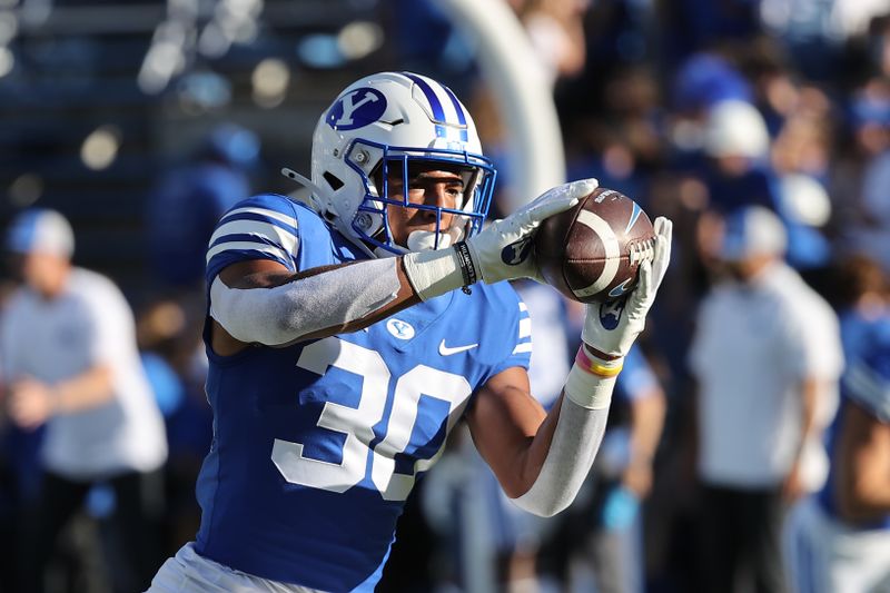 Oct 21, 2023; Provo, Utah, USA; Brigham Young Cougars running back Nukuluve Helu (30) warms up before a game against the Texas Tech Red Raiders at LaVell Edwards Stadium. Mandatory Credit: Rob Gray-USA TODAY Sports