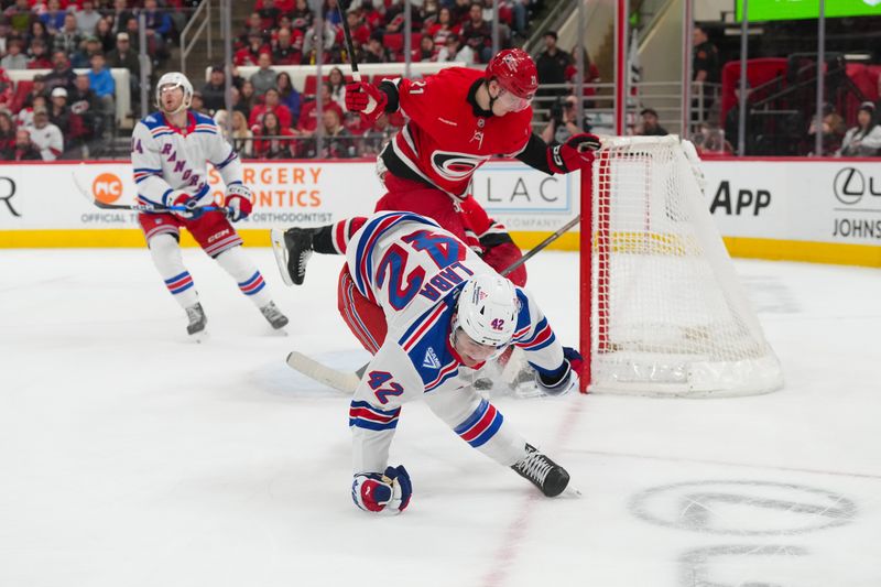 Dec 29, 2025; Raleigh, North Carolina, USA;  New York Rangers center Noah Laba (42) misses on his shot against the Carolina Hurricanes during the second period at Lenovo Center. Mandatory Credit: James Guillory-Imagn Images
