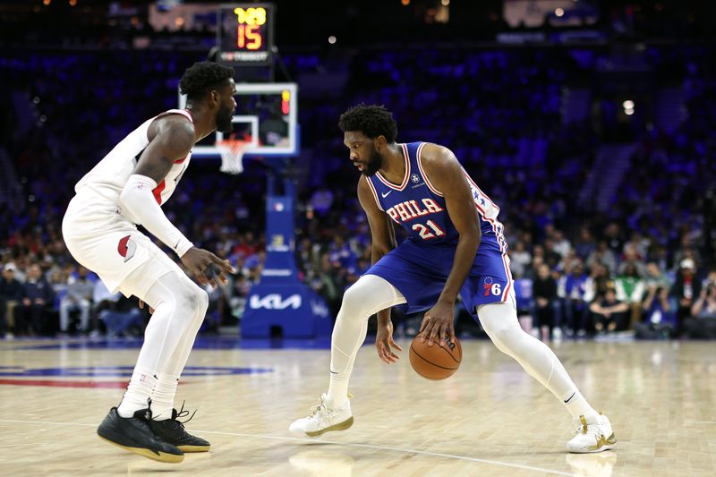 PHILADELPHIA, PENNSYLVANIA - OCTOBER 29: Joel Embiid #21 of the Philadelphia 76ers dribbles by Deandre Ayton #2 of the Portland Trail Blazers during the first quarter at Wells Fargo Center on October 29, 2023 in Philadelphia, Pennsylvania. NOTE TO USER: User expressly acknowledges and agrees that, by downloading and or using this photograph, User is consenting to the terms and conditions of the Getty Images License Agreement. (Photo by Tim Nwachukwu/Getty Images)