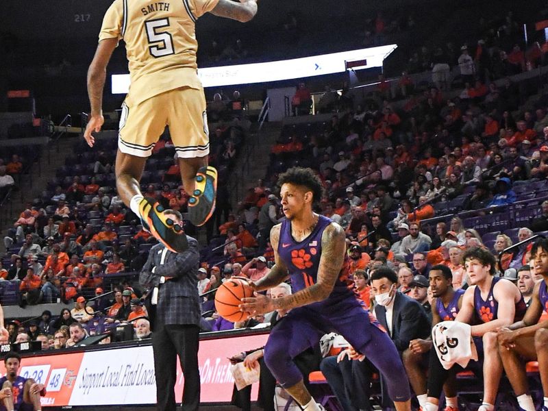 Jan 24, 2023; Clemson, South Carolina, USA; Clemson guard Brevin Galloway (11) steps to the side as Georgia Tech guard Deivon Smith (5) tries to defend him during the second half at Littlejohn Coliseum. Mandatory Credit: Ken Ruinard-USA TODAY Sports