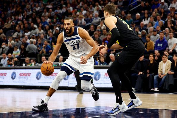 MINNEAPOLIS, MINNESOTA - NOVEMBER 30: Rudy Gobert #27 of the Minnesota Timberwolves drives to the basket while Walker Kessler #24 of the Utah Jazz defends in the third quarter at Target Center on November 30, 2023 in Minneapolis, Minnesota. The Timberwolves defeated the Jazz 101-90. NOTE TO USER: User expressly acknowledges and agrees that, by downloading and or using this photograph, User is consenting to the terms and conditions of the Getty Images License Agreement. (Photo by David Berding/Getty Images)