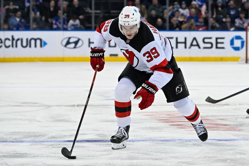 Dec 2, 2024; New York, New York, USA; New Jersey Devils left wing Mike Hardman (39) skates with the puck against the New York Rangers during the third period at Madison Square Garden. Mandatory Credit: Dennis Schneidler-Imagn Images