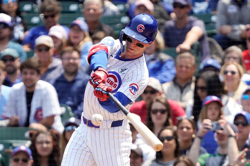 Jun 1, 2025; Chicago, Illinois, USA; Chicago Cubs outfielder Pete Crow-Armstrong (4) hits a single against the Cincinnati Reds during the first inning at Wrigley Field. Mandatory Credit: David Banks-Imagn Images