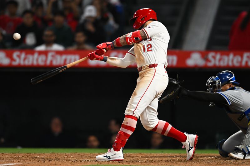 May 11, 2024; Anaheim, California, USA; Los Angeles Angels outfielder Kevin Pillar (12) hits a two run single against the Kansas City Royals during the seventh inning at Angel Stadium. Mandatory Credit: Jonathan Hui-USA TODAY Sports