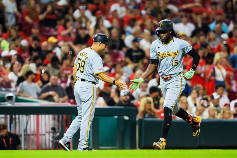 Sep 20, 2024; Cincinnati, Ohio, USA; Pittsburgh Pirates outfielder Oneil Cruz (15) high fives third base coach Mike Rabelo (58) after hitting a solo home run in the seventh inning against the Cincinnati Reds at Great American Ball Park. Mandatory Credit: Katie Stratman-Imagn Images