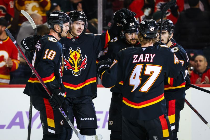 Nov 21, 2024; Calgary, Alberta, CAN; Calgary Flames center Yegor Sharangovich (17) celebrates his goal with teammates against the New York Rangers during the second period at Scotiabank Saddledome. Mandatory Credit: Sergei Belski-Imagn Images