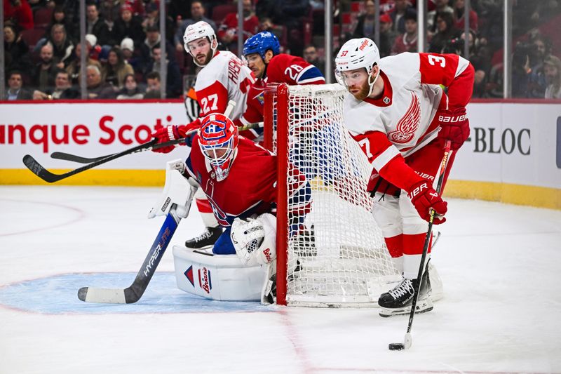 Dec 2, 2023; Montreal, Quebec, CAN; Detroit Red Wings left wing J.T. Compher (37) plays the puck near Montreal Canadiens goalie Jake Allen (34) during the second period at Bell Centre. Mandatory Credit: David Kirouac-USA TODAY Sports