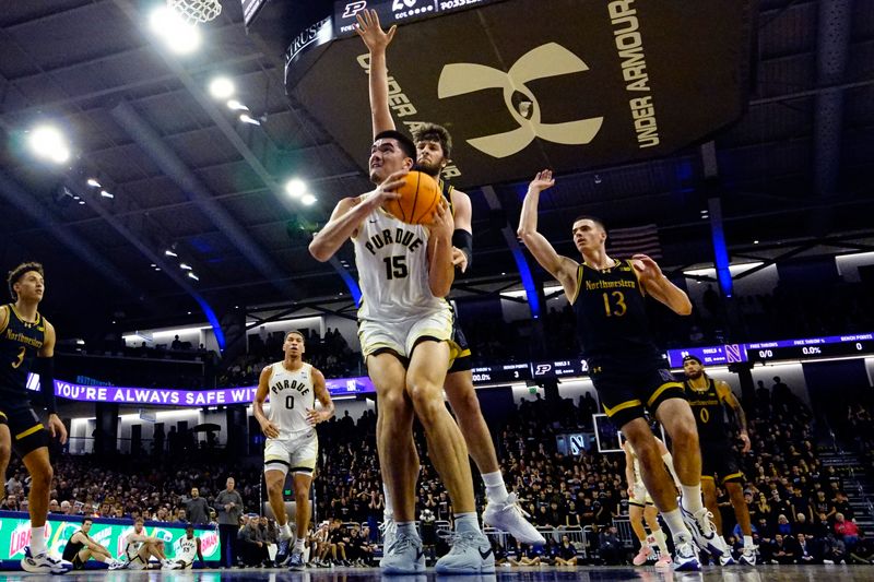 Dec 1, 2023; Evanston, Illinois, USA; Northwestern Wildcats center Matthew Nicholson (34) defends Purdue Boilermakers center Zach Edey (15) during the first half at Welsh-Ryan Arena. Mandatory Credit: David Banks-USA TODAY Sports