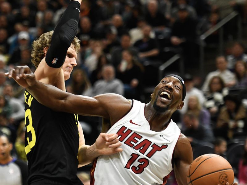 SALT LAKE CITY, UTAH - DECEMBER 30: Bam Adebayo #13 of the Miami Heat drives into Lauri Markkanen #23 of the Utah Jazz during the second half of a game at Delta Center on December 30, 2023 in Salt Lake City, Utah. NOTE TO USER: User expressly acknowledges and agrees that, by downloading and or using this photograph, User is consenting to the terms and conditions of the Getty Images License Agreement. (Photo by Alex Goodlett/Getty Images)