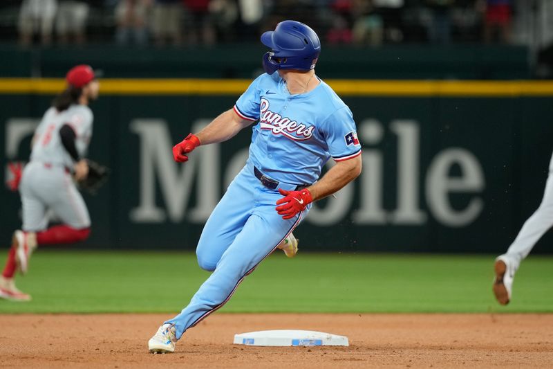 Apr 28, 2024; Arlington, Texas, USA; Texas Rangers designated hitter Wyatt Langford (36) turns and looks as he rounds the bases on his two-run inside the park home run against the Cincinnati Reds during the first inning at Globe Life Field. Langford picked up his first major league home run on the play. Mandatory Credit: Jim Cowsert-USA TODAY Sports