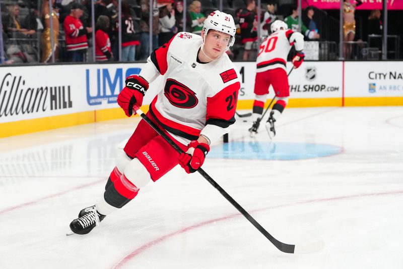 Oct 20, 2025; Las Vegas, Nevada, USA;Carolina Hurricanes defenseman Alexander Nikishin (21) warms up before a game against the Vegas Golden Knights at T-Mobile Arena. Mandatory Credit: Stephen R. Sylvanie-Imagn Images