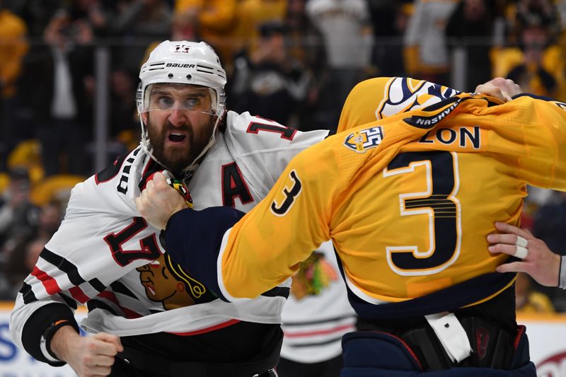 Jan 2, 2024; Nashville, Tennessee, USA; Chicago Blackhawks left wing Nick Foligno (17) and Nashville Predators defenseman Jeremy Lauzon (3) exchange punches during a fight in the second period at Bridgestone Arena. Mandatory Credit: Christopher Hanewinckel-USA TODAY Sports