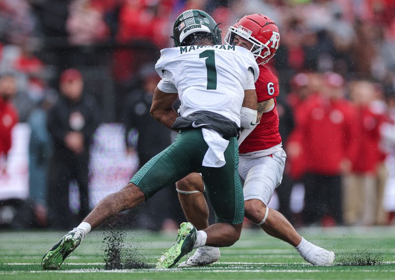 Oct 14, 2023; Piscataway, New Jersey, USA; Rutgers Scarlet Knights wide receiver Christian Dremel (6) is tackled by Michigan State Spartans defensive back Jaden Mangham (1) during the first half at SHI Stadium. Mandatory Credit: Vincent Carchietta-USA TODAY Sports