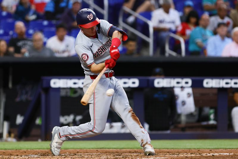 Apr 29, 2024; Miami, Florida, USA; Washington Nationals center fielder Jacob Young (30) hits a single against the Miami Marlins during the fifth inning at loanDepot Park. Mandatory Credit: Sam Navarro-USA TODAY Sports