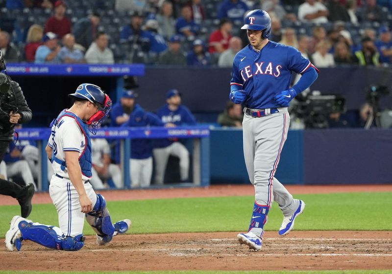 Sep 13, 2023; Toronto, Ontario, CAN; Texas Rangers designated hitter Mitch Garver (18) crosses home plate after hitting a three run home run against the Toronto Blue Jays during the ninth inning at Rogers Centre. Mandatory Credit: Nick Turchiaro-USA TODAY Sports