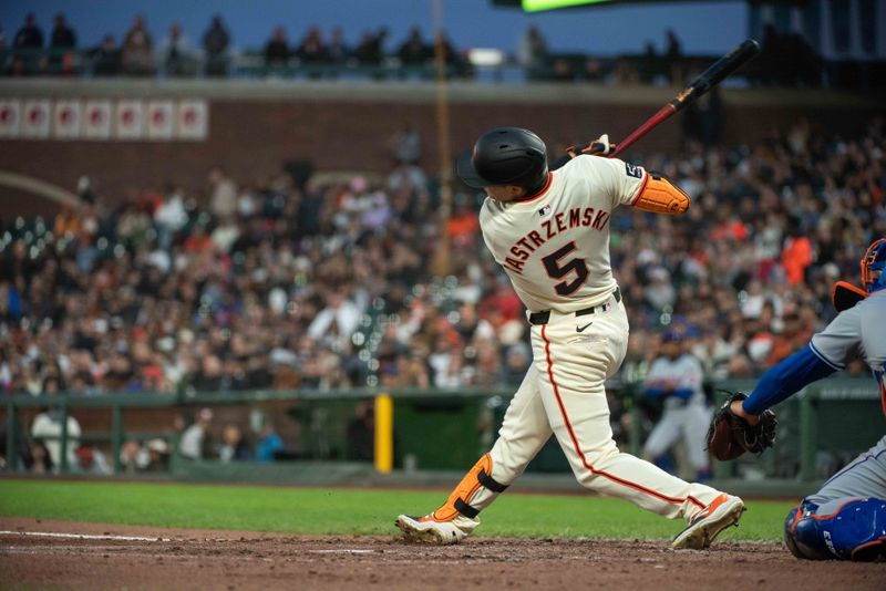 Apr 23, 2024; San Francisco, California, USA; San Francisco Giants outfielder Mike Yastrzemski (5) hits an RBI single during the fifth inning against the New York Mets at Oracle Park. Mandatory Credit: Ed Szczepanski-USA TODAY Sports