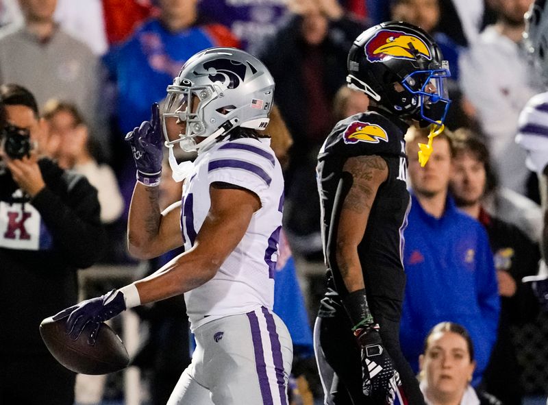 Nov 18, 2023; Lawrence, Kansas, USA; Kansas State Wildcats safety Marques Sigle (21) gestures to the crowd after intercepting a pass intended for Kansas Jayhawks wide receiver Quentin Skinner (0) during the second half at David Booth Kansas Memorial Stadium. Mandatory Credit: Jay Biggerstaff-USA TODAY Sports