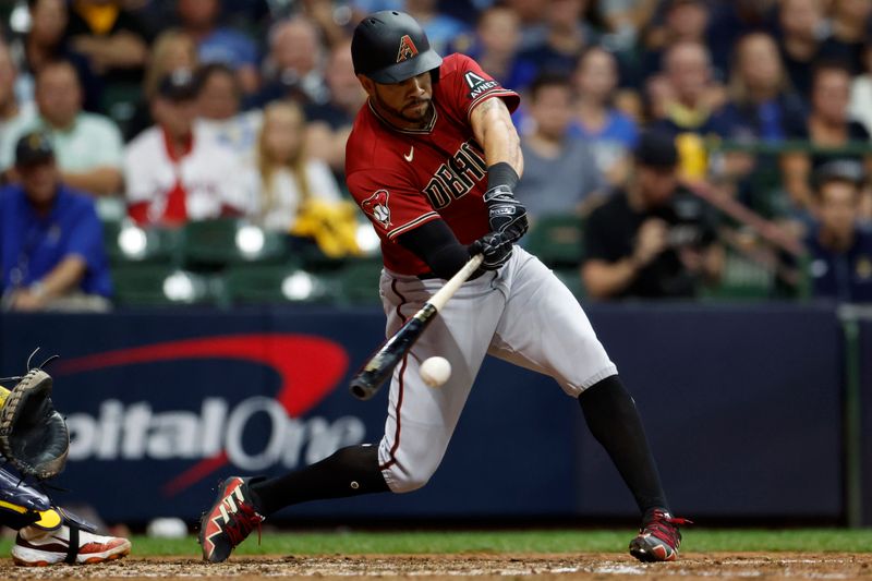 Oct 4, 2023; Milwaukee, Wisconsin, USA; Arizona Diamondbacks left fielder Tommy Pham (28) hits a single in the sixth inning against the Milwaukee Brewers during game two of the Wildcard series for the 2023 MLB playoffs at American Family Field. Mandatory Credit: Kamil Krzaczynski-USA TODAY Sports