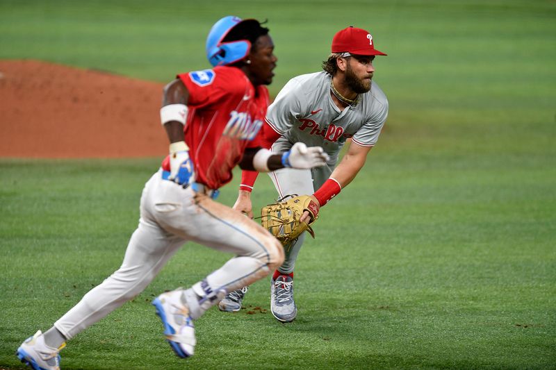 May 11, 2024; Miami, Florida, USA;  Philadelphia Phillies first baseman Bryce Harper (3) tries to throw out Miami Marlins outfielder Jazz Chisholm Jr. (2) during the fifth inning at loanDepot Park.  Chisholm Jr. was safe on the play.  Mandatory Credit: Michael Laughlin-USA TODAY Sports