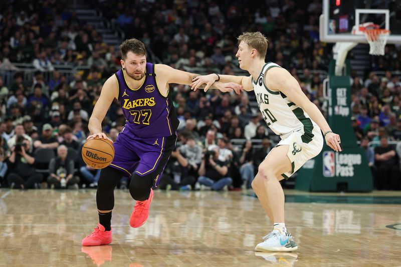 MILWAUKEE, WISCONSIN - MARCH 13: Luka Doncic #77 of the Los Angeles Lakers is defended by AJ Green #20 of the Milwaukee Bucks during a game at Fiserv Forum on March 13, 2025 in Milwaukee, Wisconsin. NOTE TO USER: User expressly acknowledges and agrees that, by downloading and or using this photograph, User is consenting to the terms and conditions of the Getty Images License Agreement. (Photo by Stacy Revere/Getty Images)