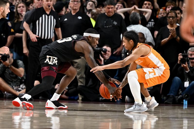 Feb 21, 2023; College Station, Texas, USA; Tennessee Volunteers guard Zakai Zeigler (5) and Texas A&M Aggies guard Tyrece Radford (23) fight for a loose ball during the second half at Reed Arena. Mandatory Credit: Maria Lysaker-USA TODAY Sports