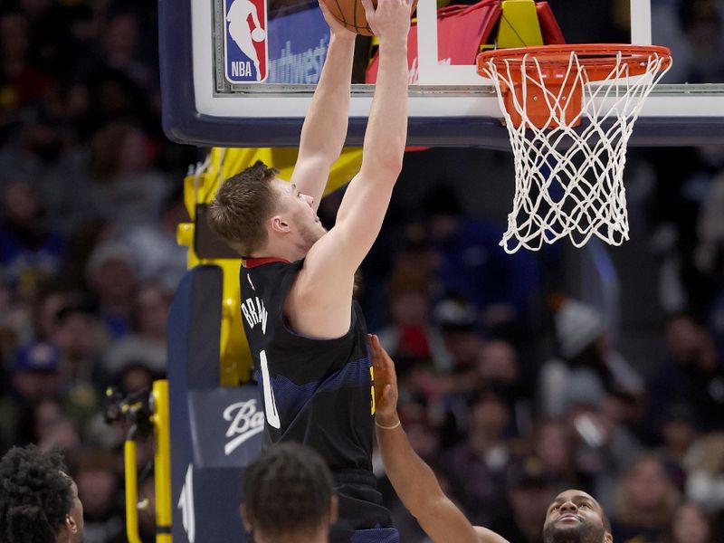 DENVER, COLORADO - JANUARY 07: Christian Braun #0 of the Denver Nuggets drives against the Detroit Pistons in the third quarter at Ball Arena on January 07, 2024 in Denver, Colorado. NOTE TO USER: User expressly acknowledges and agrees that, by downloading and or using this photograph, User is consenting to the terms and conditions of the Getty Images License Agreement.  (Photo by Matthew Stockman/Getty Images)