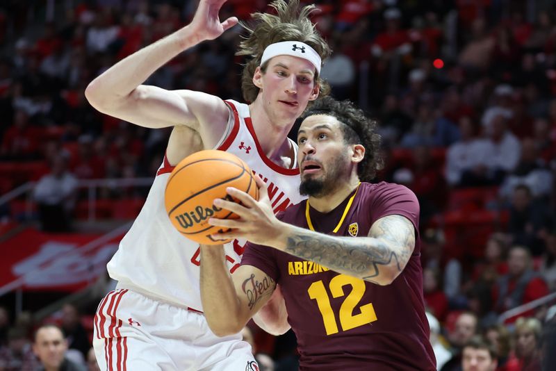 Feb 10, 2024; Salt Lake City, Utah, USA; Arizona State Sun Devils guard Jose Perez (12) goes to the basket against Utah Utes center Branden Carlson (35) during the first half at Jon M. Huntsman Center. Mandatory Credit: Rob Gray-USA TODAY Sports