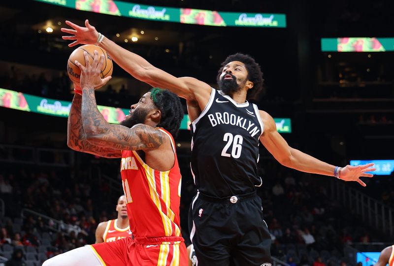 ATLANTA, GEORGIA - DECEMBER 06:  Saddiq Bey #41 of the Atlanta Hawks drives against Spencer Dinwiddie #26 of the Brooklyn Nets during the first quarter at State Farm Arena on December 06, 2023 in Atlanta, Georgia.  NOTE TO USER: User expressly acknowledges and agrees that, by downloading and/or using this photograph, user is consenting to the terms and conditions of the Getty Images License Agreement.  (Photo by Kevin C. Cox/Getty Images)