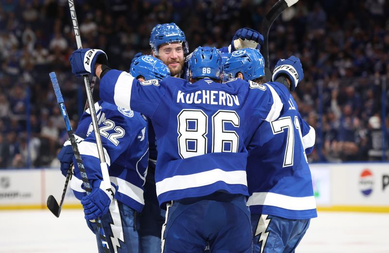 Apr 9, 2025; Tampa, Florida, USA;Tampa Bay Lightning defenseman Victor Hedman (77) is congratulated by right wing Oliver Bjorkstrand (22),  right wing Nikita Kucherov (86) and center Anthony Cirelli (71) after he scored a goal against the Toronto Maple Leafs  during the third period at Amalie Arena. Mandatory Credit: Kim Klement Neitzel-Imagn Images