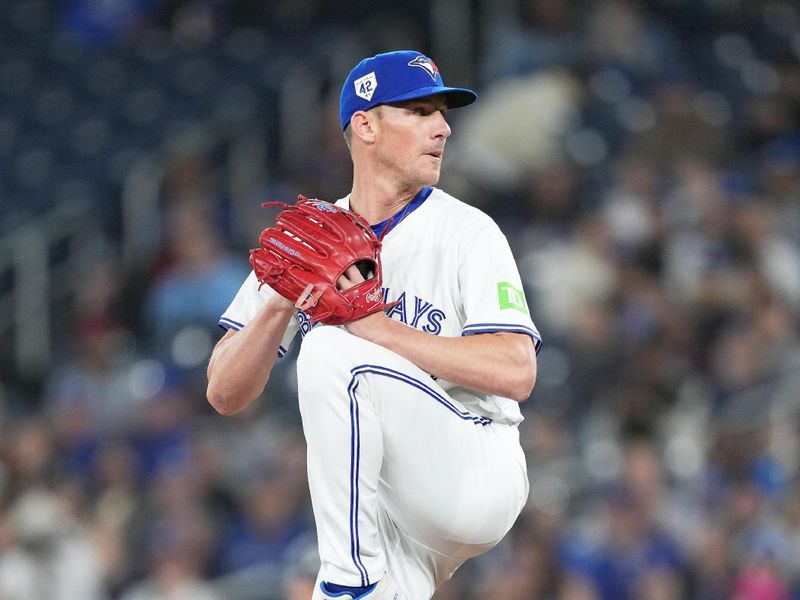 Apr 15, 2024; Toronto, Ontario, CAN; Toronto Blue Jays pitcher Chris Bassitt wearing number 42 for Jackie Robinson Day throws a pitch against the New York Yankees during the first inning at Rogers Centre. Mandatory Credit: Nick Turchiaro-USA TODAY Sports