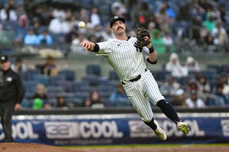 Sep 29, 2024; Bronx, New York, USA; New York Yankees third baseman Jon Berti (19) fields a ground ball by Pittsburgh Pirates shortstop Liover Peguero (31) but is unable to get the throw to first base in time during the fourth inning at Yankee Stadium. Mandatory Credit: John Jones-Imagn Images