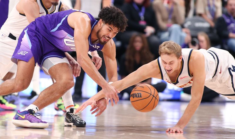 SALT LAKE CITY , UT - NOVEMBER 27:  Johnny Juzang #33 of the Utah Jazz battles for a loose ball with Hunter Tyson #5 of the Denver Nuggets during the second half of their game at the Delta Center on November 27, 2024 in Salt Lake City, Utah.  NOTE TO USER: User expressly acknowledges and agrees that, by downloading and or using this photograph, User is consenting to the terms and conditions of the Getty Images License Agreement. (Photo by Chris Gardner/Getty Images)