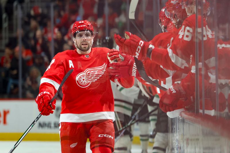 Jan 23, 2024; Detroit, Michigan, USA;  Detroit Red Wings left wing David Perron (57) receives congratulations from teammates after scoring in the first period against the Dallas Stars at Little Caesars Arena. Mandatory Credit: Rick Osentoski-USA TODAY Sports