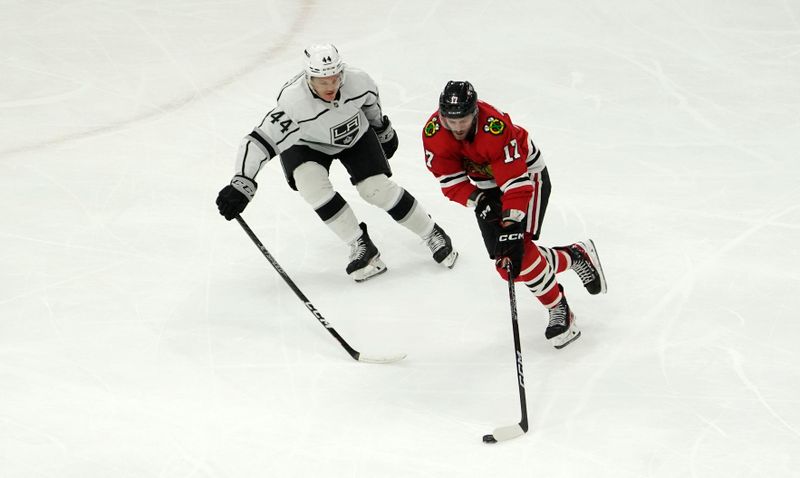 Jan 22, 2023; Chicago, Illinois, USA; Los Angeles Kings defenseman Mikey Anderson (44) defends Chicago Blackhawks center Jason Dickinson (17) during the first period at United Center. Mandatory Credit: David Banks-USA TODAY Sports