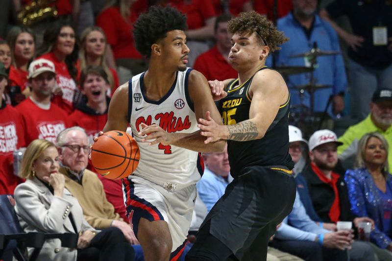 Feb 17, 2024; Oxford, Mississippi, USA; Mississippi Rebels forward Jaemyn Brakefield (4) handles the ball as Missouri Tigers forward Noah Carter (35) defends during the first half at The Sandy and John Black Pavilion at Ole Miss. Mandatory Credit: Petre Thomas-USA TODAY Sports