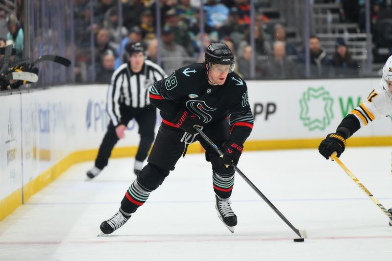 Jan 6, 2026; Seattle, Washington, USA; Seattle Kraken left wing Jared McCann (19) advances the puck against the Boston Bruins during the second period at Climate Pledge Arena. Mandatory Credit: Steven Bisig-Imagn Images