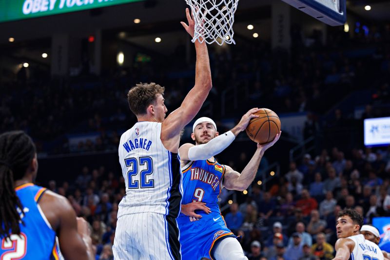 OKLAHOMA CITY, OKLAHOMA - NOVEMBER 4: Alex Caruso #9 of the Oklahoma City Thunder goes to the basket in the first half against Franz Wagner #22 of the Orlando Magic at Paycom Center on November 4, 2024 in Oklahoma City, Oklahoma. NOTE TO USER: User expressly acknowledges and agrees that, by downloading and or using this Photograph, user is consenting to the terms and conditions of the Getty Images License Agreement. (Photo by Wesley Hitt/Getty Images)