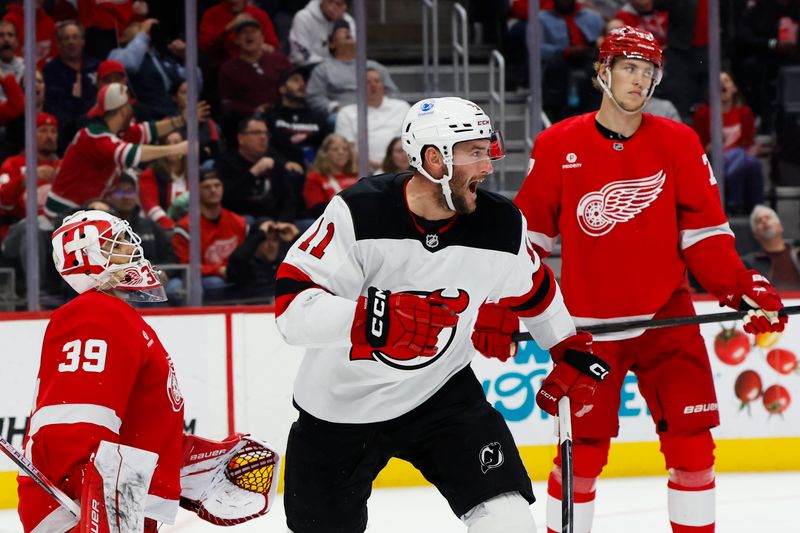 Oct 24, 2024; Detroit, Michigan, USA;  New Jersey Devils right wing Stefan Noesen (11) celebrates a goal by center Nico Hischier (not pictured) in the third period against the Detroit Red Wings at Little Caesars Arena. Mandatory Credit: Rick Osentoski-Imagn Images