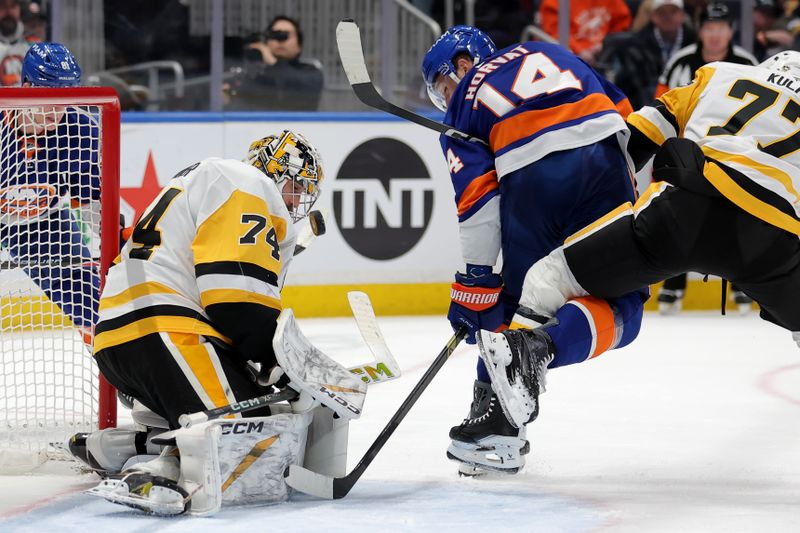 Feb 3, 2026; Elmont, New York, USA; Pittsburgh Penguins goaltender Stuart Skinner (74) makes a save against New York Islanders center Bo Horvat (14) during the second period at UBS Arena. Mandatory Credit: Brad Penner-Imagn Images