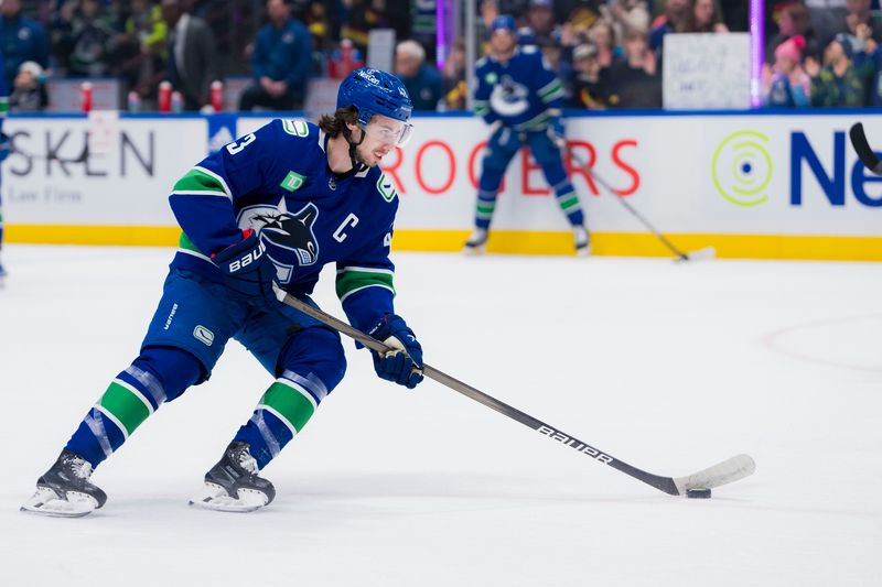 Mar 9, 2024; Vancouver, British Columbia, CAN; Vancouver Canucks defenseman Quinn Hughes (43) handles the puck during warm up prior to a game against the Winnipeg Jets at Rogers Arena. Mandatory Credit: Bob Frid-USA TODAY Sports