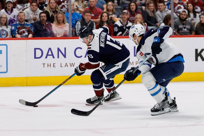 Apr 13, 2024; Denver, Colorado, USA; Colorado Avalanche right wing Valeri Nichushkin (13) controls the puck as Winnipeg Jets defenseman Dylan DeMelo (2) defends in the second period at Ball Arena. Mandatory Credit: Isaiah J. Downing-USA TODAY Sports