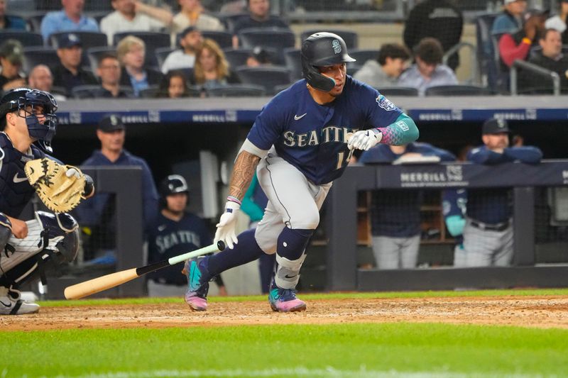 Jun 22, 2023; Bronx, New York, USA;  Seattle Mariners second baseman Kolten Wong (16) hits a single during the seventh inning against the New York Yankees at Yankee Stadium. Mandatory Credit: Gregory Fisher-USA TODAY Sports