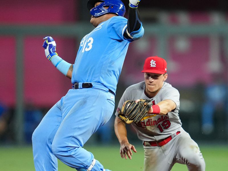 Aug 11, 2023; Kansas City, Missouri, USA; Kansas City Royals catcher Salvador Perez (13) is tagged out while trying to stretch a single against St. Louis Cardinals shortstop Tommy Edman (19) during the seventh inning at Kauffman Stadium. Mandatory Credit: Jay Biggerstaff-USA TODAY Sports