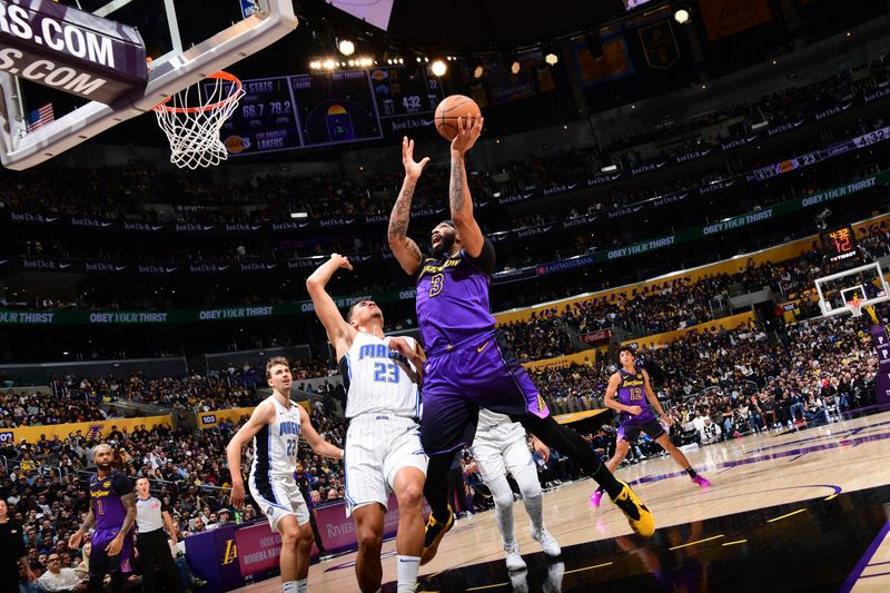 LOS ANGELES, CA - NOVEMBER 21: Anthony Davis #3 of the Los Angeles Lakers drives to the basket during the game against the Orlando Magic on November 21, 2024 at Crypto.Com Arena in Los Angeles, California. NOTE TO USER: User expressly acknowledges and agrees that, by downloading and/or using this Photograph, user is consenting to the terms and conditions of the Getty Images License Agreement. Mandatory Copyright Notice: Copyright 2024 NBAE (Photo by Adam Pantozzi/NBAE via Getty Images)