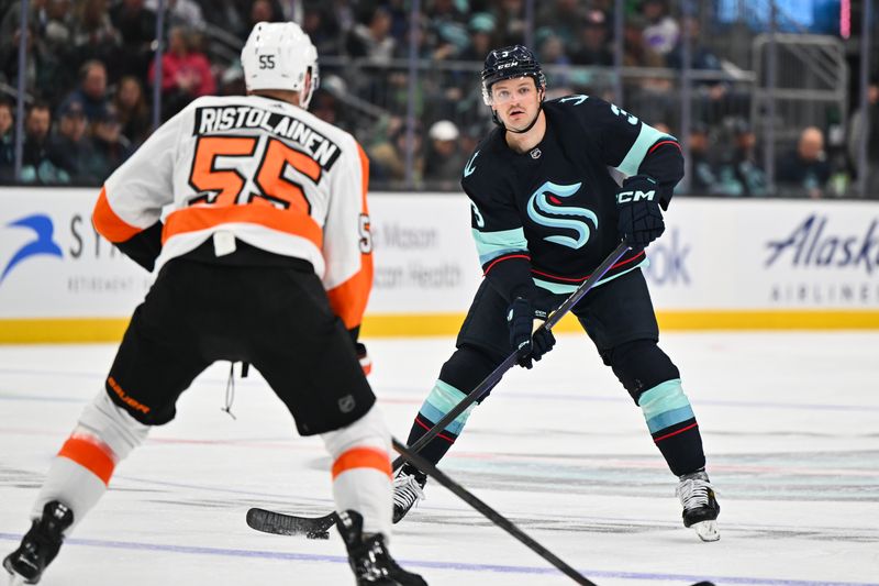 Feb 16, 2023; Seattle, Washington, USA; Seattle Kraken defenseman Will Borgen (3) looks to pass the puck while being defended by Philadelphia Flyers defenseman Rasmus Ristolainen (55) during the third period at Climate Pledge Arena. Seattle defeated Philadelphia 6-2. Mandatory Credit: Steven Bisig-USA TODAY Sports