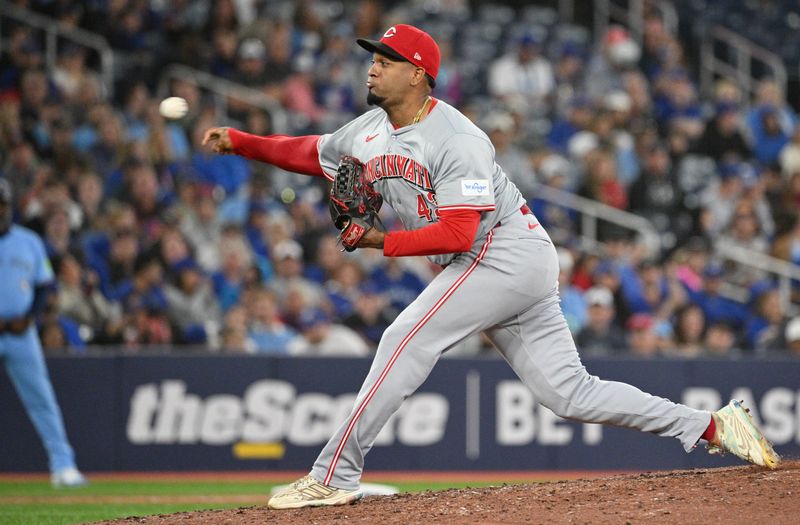 Aug 19, 2024; Toronto, Ontario, CAN; Cincinnati Reds relief pitcher Alexis Diaz (43) delivers a pitch against the Toronto Blue Jays in the ninth inning at Rogers Centre. Mandatory Credit: Dan Hamilton-USA TODAY Sports