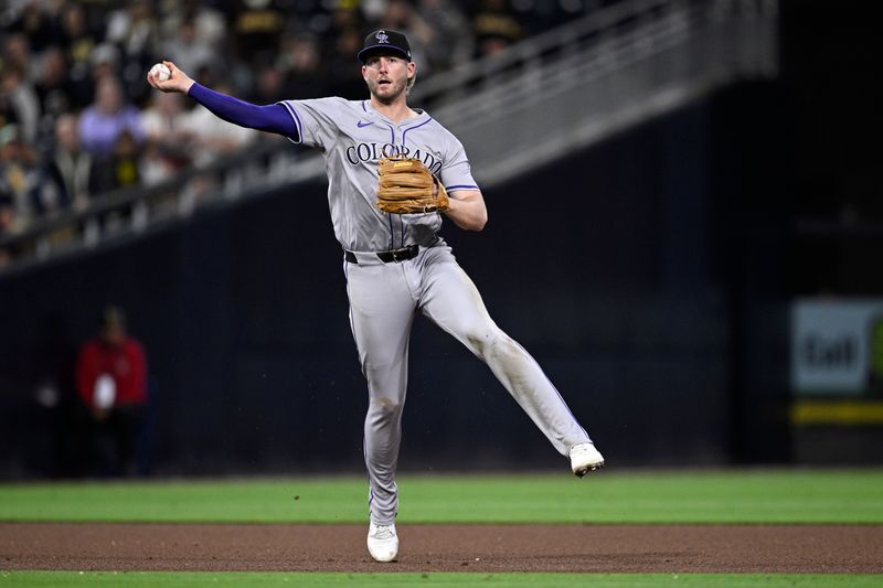 May 13, 2024; San Diego, California, USA; Colorado Rockies third baseman Ryan McMahon (24) throws to first base on a ground out by San Diego Padres right fielder Fernando Tatis Jr. (not pictured) during the seventh inning at Petco Park. Mandatory Credit: Orlando Ramirez-USA TODAY Sports